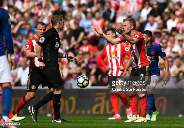 Sebastian Larsson of Sunderland reacts before being sent off by referee Craig Pawson for a challenge on Ander Herrera of Manchester United during the...