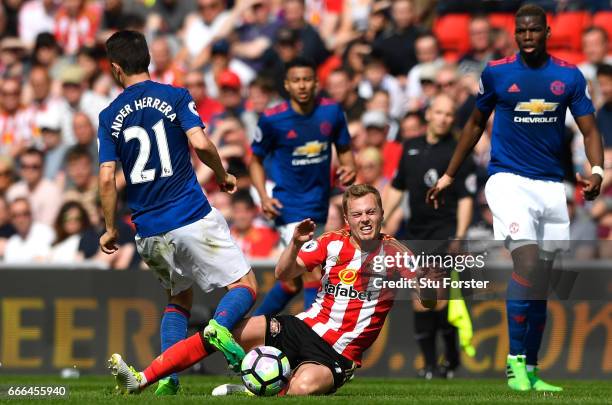 Sebastian Larsson of Sunderland fouls Ander Herrera of Manchester United leading to his sending off during the Premier League match between...