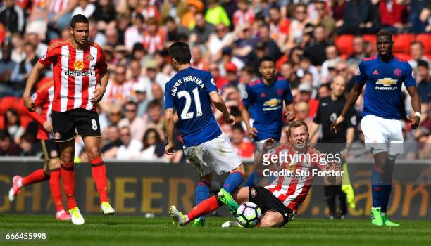 Sebastian Larsson of Sunderland fouls Ander Herrera of Manchester United leading to his sending off during the Premier League match between...