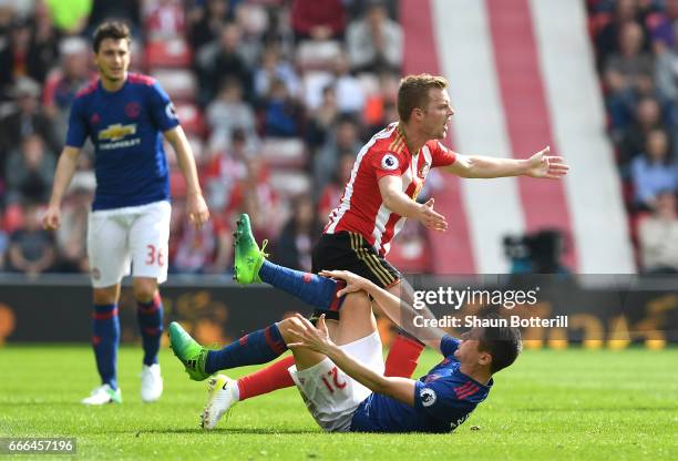 Sebastian Larsson of Sunderland fouls Ander Herrera of Manchester United leading to his sending off during the Premier League match between...