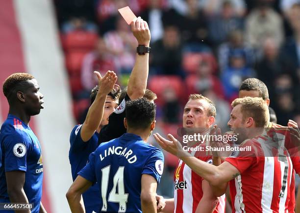 Sebastian Larsson of Sunderland reacts after being sent off by referee Craig Pawson for a challenge on Ander Herrera of Manchester United during the...