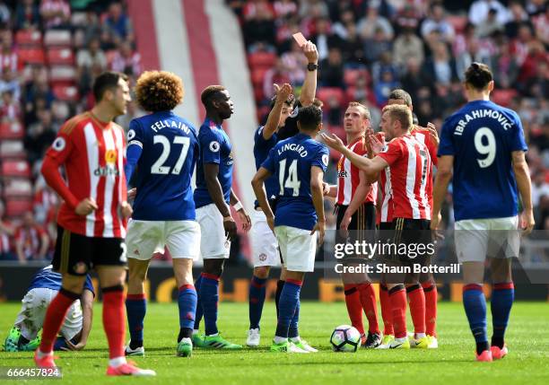 Sebastian Larsson of Sunderland reacts after being sent off by referee Craig Pawson for a challenge on Ander Herrera of Manchester United during the...