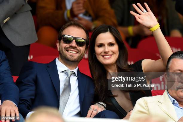Paul Baccaglini, President of Palermo, and Thais Souza Wiggers wave during the Serie A match between AC Milan and US Citta di Palermo at Stadio...