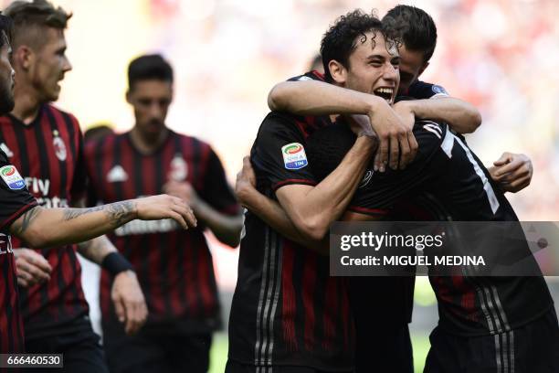 Milan's forward from Colombia Carlos Bacca celebrates with teammates after scoring during the Italian Serie A football match AC Milan vs Palermo on...