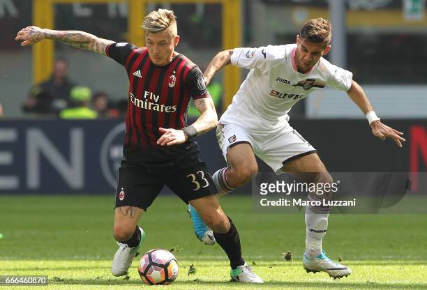 Juraj Kucka of AC Milan competes for the ball with Ivaylo Chochev of US Citta di Palermo during the Serie A match between AC Milan and US Citta di...