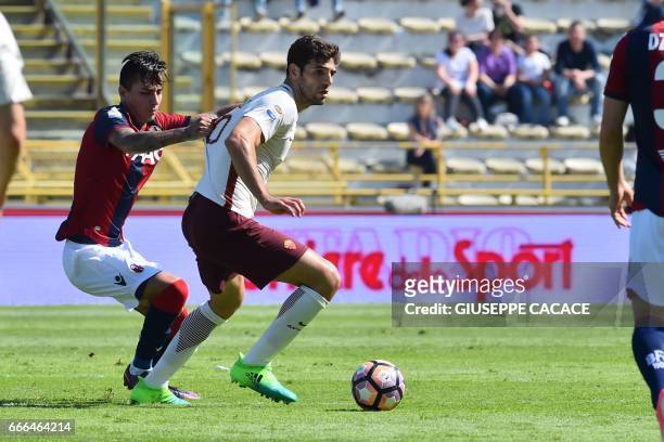 Roma's defender Federico Fazio from Argentina fights for the ball with Bologna's defender from Chile Erick Pulgar during the Italian Serie A football...