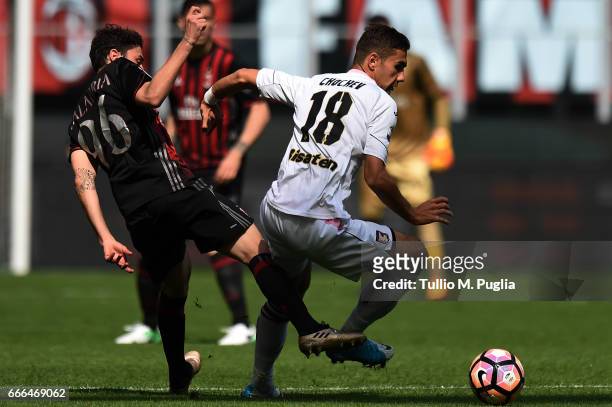 Ivaylo Chochev of Palermo is challenged by Davide Calabria of Milan during the Serie A match between AC Milan and US Citta di Palermo at Stadio...