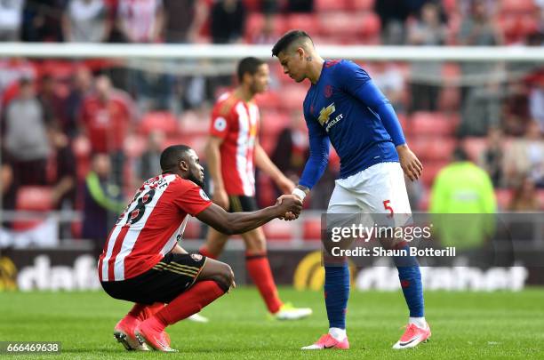 Victor Anichebe of Sunderland shakes hands with Marcos Rojo of Manchester United after the Premier League match between Sunderland and Manchester...