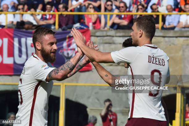 Roma's forward from Bosnia-Herzegovina Edin Dzeko celebrates after scoring a goal with Roma's midfielder from Italy Daniele De Rossi during the...