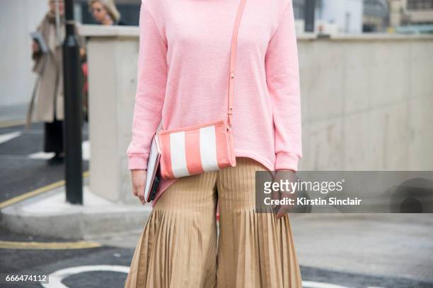 TFashion buyer Jeannie Lee wears a Balenciaga bag on day 4 of London Womens Fashion Week Autumn/Winter 2017, on February 20, 2017 in London, England.
