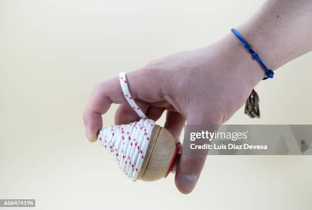 boy's hand wrapped with the string of a spinning top - parte del cuerpo humano stock pictures, royalty-free photos & images