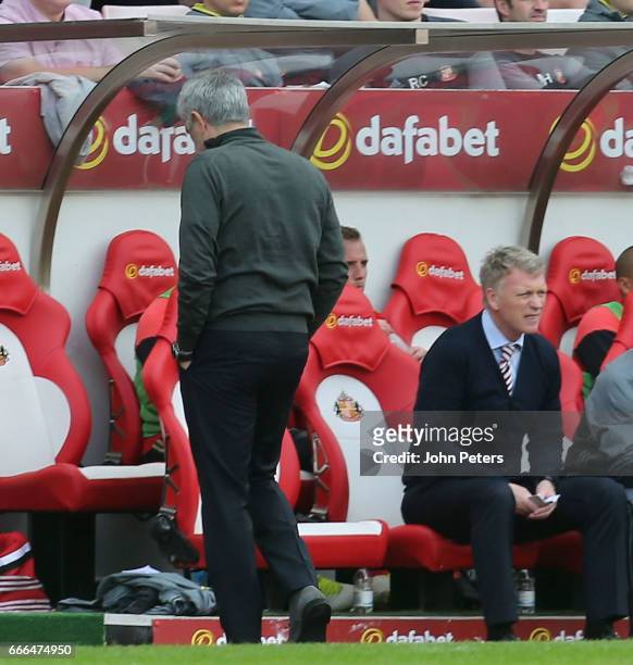 Manager Jose Mourinho of Manchester United and Manager David Moyes of Sunderland watch from the touchline during the Premier League match between...