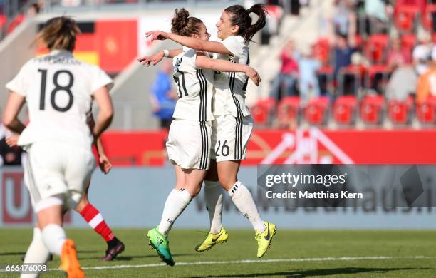 Linda Dallman of Germany jubilates with team mate Hasret Kayikci after scoring the third goal during the women's international friendly match between...