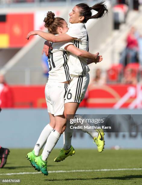 Linda Dallman of Germany jubilates with team mate Hasret Kayikci after scoring the third goal during the women's international friendly match between...
