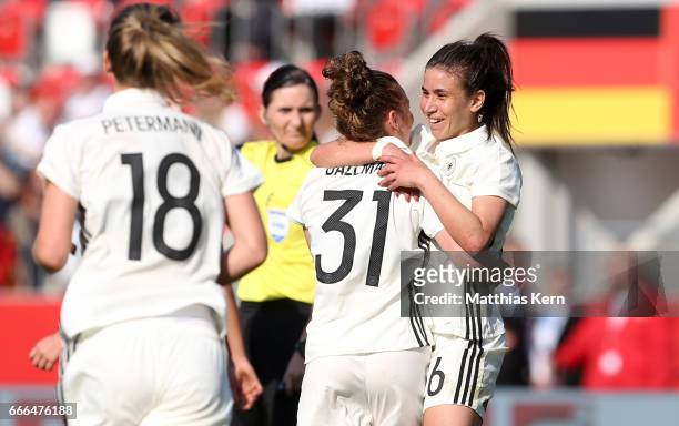 Linda Dallman of Germany jubilates with team mate Hasret Kayikci after scoring the third goal during the women's international friendly match between...