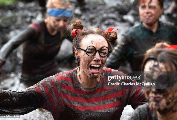 Runner grimaces making her way through a mud sink hole as competitors take part in the annual McVities Mud Madness 8km cross country run on April 9,...
