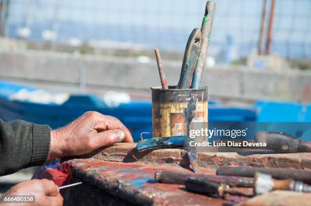 repairing a leak on the boat's hull - vestimenta informal stock pictures, royalty-free photos & images