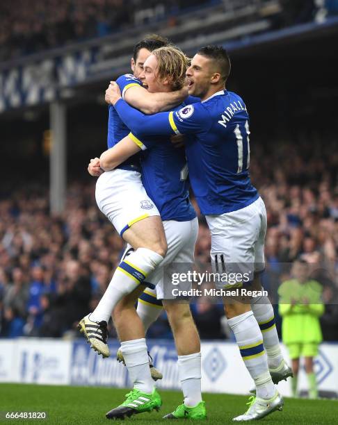 Tom Davies of Everton celebrates scoring the opening goal with Kevin Mirallas during the Premier League match between Everton and Leicester City at...