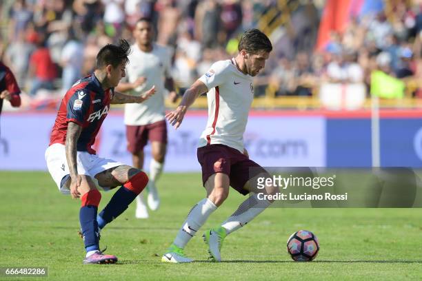 Kevin Strootman of AS Roma is challenged by Erick Pulgar of Bologna FC during the Serie A match between Bologna FC and AS Roma at Stadio Renato...
