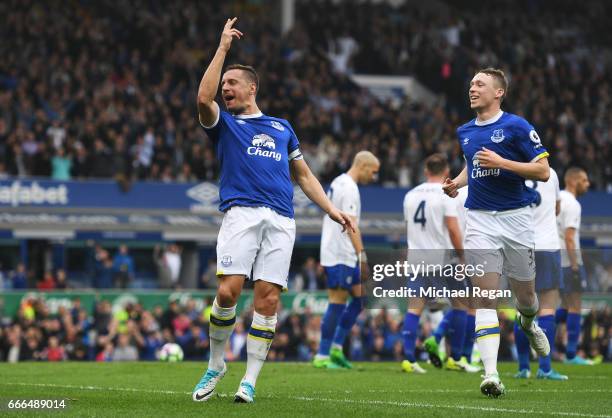 Phil Jagielka of Everton celebrates scoring his team's third goal with Matthew Pennington during the Premier League match between Everton and...