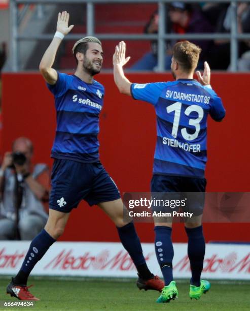 Mario Vrancic of Darmstadt celebrates his team's first goal with team mate Markus Steinhoefer during the Bundesliga match between FC Ingolstadt 04...