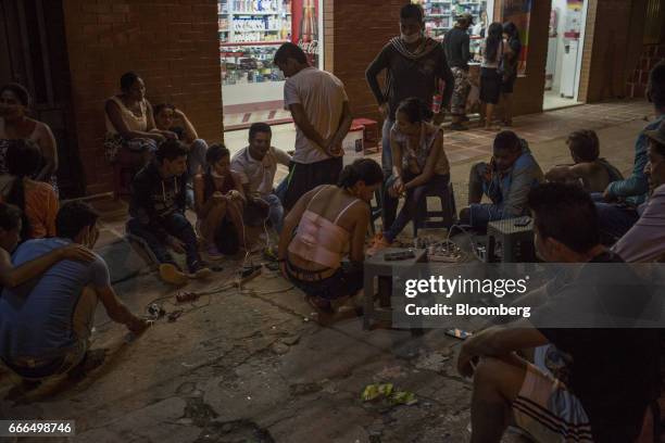 Displaced residents charger electronic devices from a gas generator after landslides after landslides in Mocoa, Putumayo, Colombia, on Monday, April...