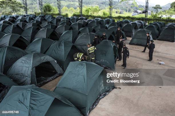 Police officers set up tents at a disaster relief center after landslides in Mocoa, Putumayo, Colombia, on Monday, April 3, 2017. Torrential rains...