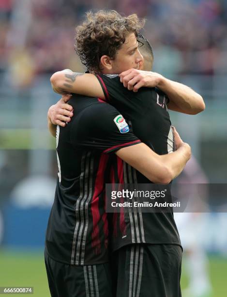 Manuel Locatelli of AC Milan embraces Gianluca Lapadula of AC Milan during the Serie A match between AC Milan and US Citta di Palermo at Stadio...