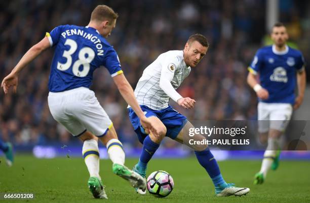 Everton's English defender Matthew Pennington vies with Leicester City's English striker Jamie Vardy during the English Premier League football match...