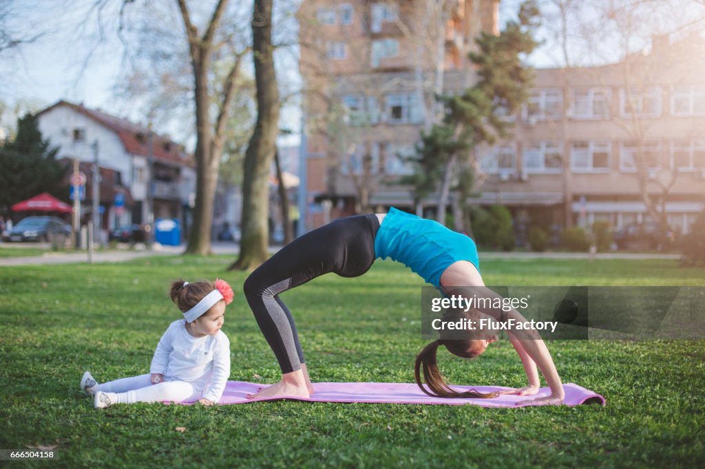Bridge pose with a daughter looking