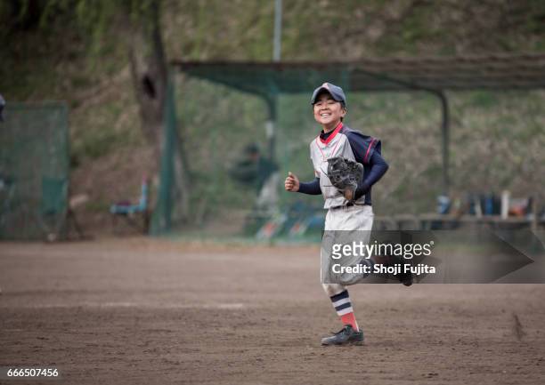 youth baseball players,playing game,substitution - baseball strip stock-fotos und bilder
