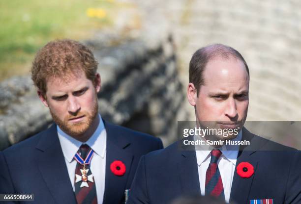 Prince William, Duke of Cambridge and Prince Harry walk through a trench during the commemorations for the 100th anniversary of the battle of Vimy...
