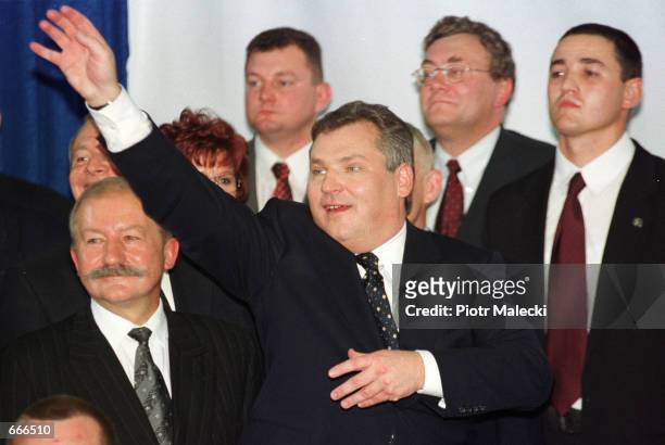 Aleksander Kwasniewski waves to supporters October 8, 2000 in Warsaw while celebrating after winning a second term in office as Polish President....