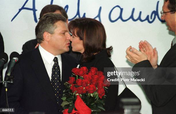 Aleksander Kwasniewski kisses his wife Jolanta October 8, 2000 in Warsaw after winning a second term in office as Polish President. Kwasniewski an...