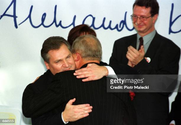 Aleksander Kwasniewski gets a hug from a supporter October 8, 2000 in Warsaw after winning a second term in office as Polish President. Kwasniewski...