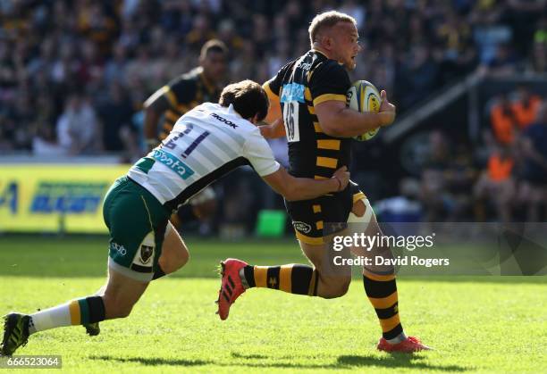 Tom Cruse of Wasps breaks clear of Lee Dickson during the Aviva Premiership match between Wasps and Northampton Saints at The Ricoh Arena on April 9,...