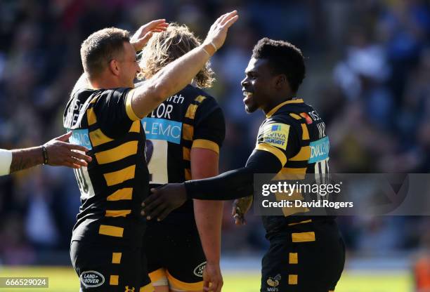 Christian Wade of Wasps celebrates with team mate Jimmy Gopperth after scoring a try during the Aviva Premiership match between Wasps and Northampton...