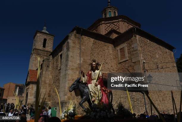 An effigy of a Christian icon know as 'La borriquilla', which represents the triumphal entry of Jesus into Jerusalem, is carried by penitents during...