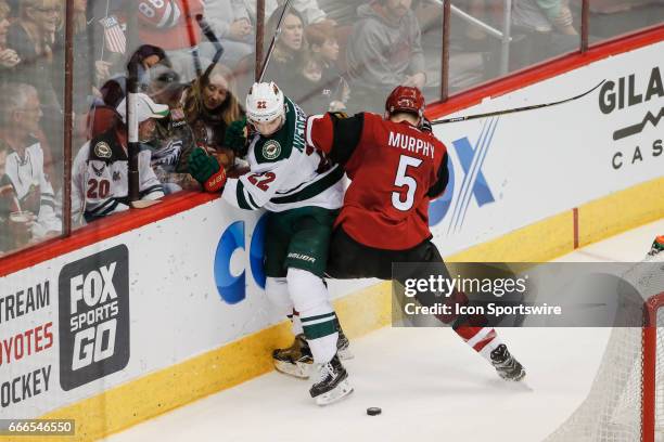 Arizona Coyotes defenseman Connor Murphy checks Minnesota Wild right wing Nino Niederreiter during the NHL hockey game between the Minnesota Wild and...