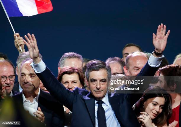 Former French Prime Minister and French presidential elections candidate for the right-wing "Les Republicains" political party Francois Fillon waves...