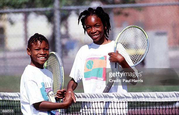 Sisters Serena, left, and Venus Williams shake hands after a game 1991 in Compton, CA. Serena and Venus Williams will be playing against each other...