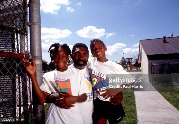 Richard Williams, center, with his daughters Venus, left, and Serena 1991 in Compton, CA. Serena and Venus Williams will be playing against each...
