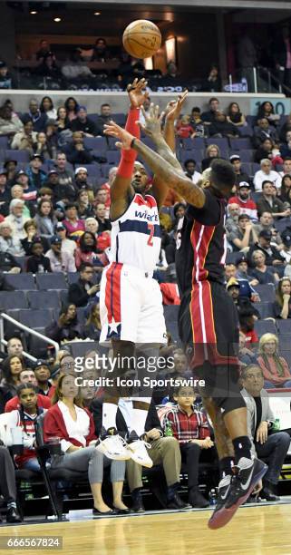 Washington Wizards guard John Wall scores in the first half against Miami Heat forward James Johnson on April 8 at the Verizon Center in Washington,...