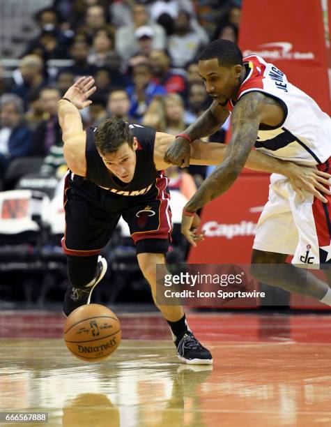 Miami Heat guard Goran Dragic fights for a turnover in the first half with Washington Wizards guard Brandon Jennings on April 8 at the Verizon Center...