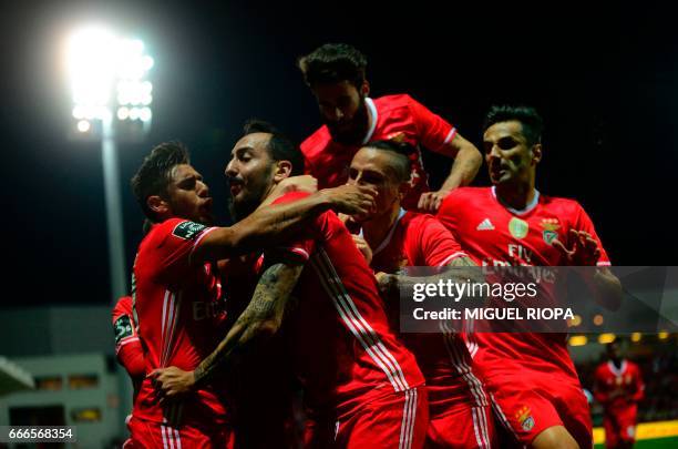 Benfica's Greek forward Konstantinos Mitroglou celebrates with teammates after scoring a goal during the Portuguese league football match Moreirense...