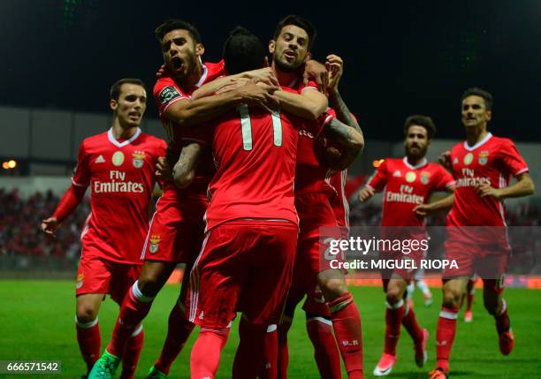 Benfica's Greek forward Konstantinos Mitroglou celebrates with teammates after scoring a goal during the Portuguese league football match Moreirense...