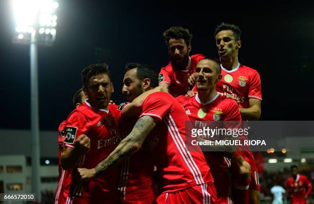 Benfica's Greek forward Konstantinos Mitroglou is congratulated by teammtes after scoring a goal during the Portuguese league football match...