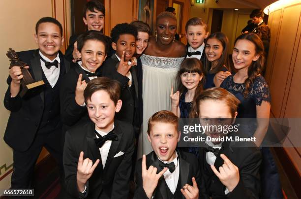 Laura Mvula poses with the kids from "School Of Rock: The Musical", winners of the Outstanding Achievement In Music award, in the winners room at The...