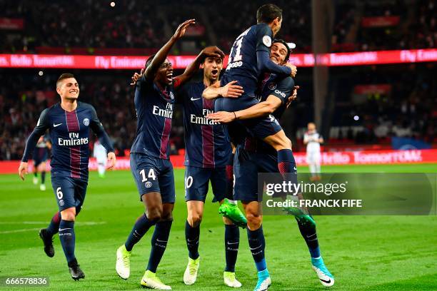 Paris Saint-Germain's Argentinian forward Angel Di Maria and Paris Saint-Germain's Uruguayan forward Edinson Cavani celebrate with teammates after...