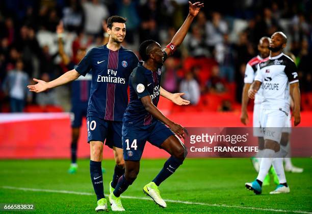 Paris Saint-Germain's French midfielder Blaise Matuidi celebrates with his teammates after scoring a goal during the French L1 football match between...